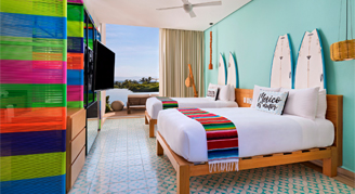 Image of two beds in a Deluxe Lake-View Room.