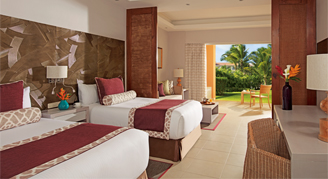 Image of two beds in a room leading to a patio.