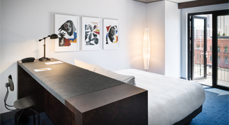 Photo of one king bed and work desk.