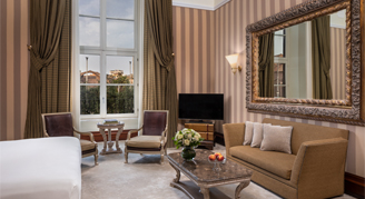 Warm tone elegant Suite at Anantara Naiadi Rome