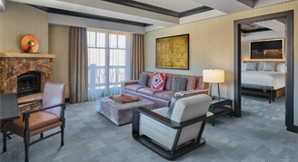 Photo of the suite living room with doorway into the bedroom.