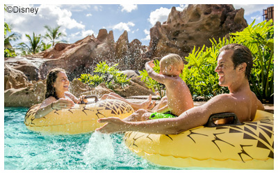 Two children in innertubes on a lazy river