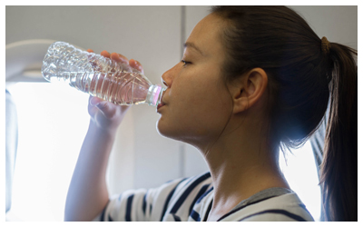 Woman drinking from a water bottle