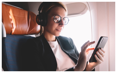 Woman with a cell phone in an airplane