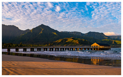 Coastal view of Hanalei Pier and the island mountains in the background