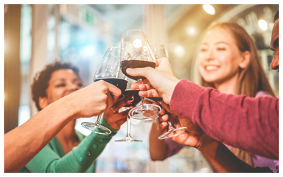 Image of people smiling and toasting wine glasses.