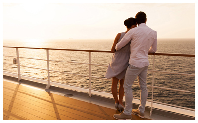 Couple watching a sunrise aboard a cruise ship