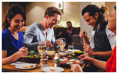 Friends eating dinner at a restaurant