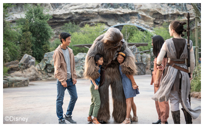 Chewbacca hugging two kids.